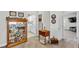 This hallway features a glass display cabinet, decor, and access to the laundry room and a living area at 10420 Loma Portal Ave, Las Vegas, NV 89166