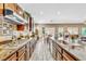 Modern kitchen with granite countertops, wooden cabinets, and an open layout at 10420 Loma Portal Ave, Las Vegas, NV 89166