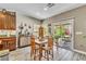 Eat-in kitchen with stainless steel appliances, granite countertops, and access to outdoor patio at 10420 Loma Portal Ave, Las Vegas, NV 89166