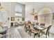 Bright living area featuring a dining set, lounge seating, and ample natural light from large windows at 10420 Loma Portal Ave, Las Vegas, NV 89166
