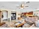 Open-concept living room featuring a fireplace, comfortable seating, and seamless access to the kitchen at 10420 Loma Portal Ave, Las Vegas, NV 89166