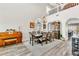 Well-lit living room combines dining and lounge area, with two-story ceiling and abundant natural light at 10420 Loma Portal Ave, Las Vegas, NV 89166