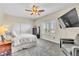 Bright main bedroom with a large window, ceiling fan, TV, and closet featuring ample storage at 10420 Loma Portal Ave, Las Vegas, NV 89166