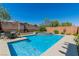 Sparkling pool with spa, perfect for relaxation, with an outdoor dining area, and manicured landscaping at 10420 Loma Portal Ave, Las Vegas, NV 89166