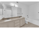 Bright bathroom featuring double sinks, granite countertops, and separate tub and toilet areas at 10550 W Alexander Rd # 2079, Las Vegas, NV 89129