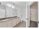 Bright bathroom featuring double sinks, granite countertops, and separate tub and toilet areas at 10550 W Alexander Rd # 2079, Las Vegas, NV 89129