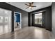 Stylish bedroom with fan, wood-look floors, and large window, plus bathroom and closet access at 10550 W Alexander Rd # 2079, Las Vegas, NV 89129