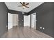 Bedroom featuring an attached walk-in closet and wood-look floors, plus modern ceiling fan at 10550 W Alexander Rd # 2079, Las Vegas, NV 89129