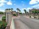 Community entrance with lush landscaping and palm trees, creating a welcoming atmosphere at 10550 W Alexander Rd # 2079, Las Vegas, NV 89129