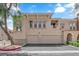 Exterior view of townhome with two-car garages, neutral paint, and well-kept landscaping at 10550 W Alexander Rd # 2079, Las Vegas, NV 89129