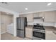 Updated kitchen featuring stainless steel appliances, granite counters, and a door leading to the laundry room at 10550 W Alexander Rd # 2079, Las Vegas, NV 89129