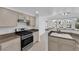 Updated kitchen featuring granite countertops, stainless steel appliances, and an open layout with adjacent living space at 10550 W Alexander Rd # 2079, Las Vegas, NV 89129
