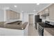 Well-lit kitchen features granite countertops, tile flooring, stainless steel appliances, and updated cabinets at 10550 W Alexander Rd # 2079, Las Vegas, NV 89129