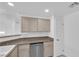 Well-lit kitchen featuring stainless steel dishwasher, granite countertops, and neutral colored cabinets at 10550 W Alexander Rd # 2079, Las Vegas, NV 89129