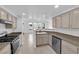 Open kitchen with granite countertops, stainless steel appliances, and convenient bar seating with view to living space at 10550 W Alexander Rd # 2079, Las Vegas, NV 89129