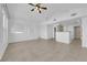 Spacious living room featuring tile flooring, an open floorplan, and a ceiling fan in a neutral color palette at 10550 W Alexander Rd # 2079, Las Vegas, NV 89129
