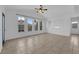 Bright living space with neutral tile floors, ceiling fan, and large windows overlooking the neighborhood at 10550 W Alexander Rd # 2079, Las Vegas, NV 89129