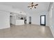 Bright and airy living room with tile flooring, ceiling fan, and view into open kitchen in neutral color palette at 10550 W Alexander Rd # 2079, Las Vegas, NV 89129