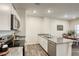 Bright kitchen featuring white cabinets, stainless steel appliances, gray countertops, and hardwood floors at 12728 Feathersong St, Henderson, NV 89044