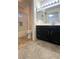 Bathroom featuring a shower and a vanity sink with dark cabinets at 1533 Linnbaker Ln # 102, Las Vegas, NV 89110