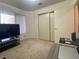 Bedroom featuring a large window, neutral walls, closet, and carpeted floors at 1533 Linnbaker Ln # 102, Las Vegas, NV 89110