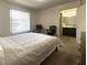 Bright bedroom features a window with blinds and an ensuite bathroom entrance at 1533 Linnbaker Ln # 102, Las Vegas, NV 89110
