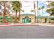 Exterior shot of a community clubhouse featuring pedestrian walkways, an outdoor lounge, and desert landscaping at 1533 Linnbaker Ln # 102, Las Vegas, NV 89110