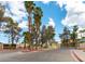 Exterior shot of community entrance, showcasing signage and manned security booth in a park-like setting at 1533 Linnbaker Ln # 102, Las Vegas, NV 89110