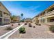 Exterior view of the apartment complex featuring landscaped walkways and desert landscaping at 1533 Linnbaker Ln # 102, Las Vegas, NV 89110