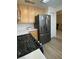 Kitchen featuring wood cabinets, stainless steel fridge, gas range, and light-colored countertops at 1533 Linnbaker Ln # 102, Las Vegas, NV 89110