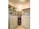 Functional laundry room with washer, dryer, and ample shelving for storage at 1533 Linnbaker Ln # 102, Las Vegas, NV 89110