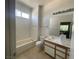 Full bathroom with large mirror and white cabinets at 1667 Marion Bennet Dr, Las Vegas, NV 89106