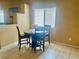 Cozy dining area with a round table, seating for four, and natural light from a nearby window at 1667 Marion Bennet Dr, Las Vegas, NV 89106