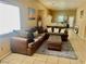 Inviting living room featuring comfortable sofas, neutral decor, and a cozy rug over tile floors at 1667 Marion Bennet Dr, Las Vegas, NV 89106
