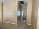 Neutral toned living area with ceramic tile flooring leading to hallway and other rooms at 1667 Marion Bennet Dr, Las Vegas, NV 89106