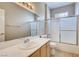 Bathroom featuring vanity lights, a large mirror and a tub-shower combo at 1713 Sky Of Red Dr # 203, Las Vegas, NV 89128