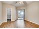 Bedroom features wood laminate flooring, sliding glass doors and a walk-in closet at 1713 Sky Of Red Dr # 203, Las Vegas, NV 89128