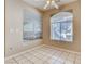 Well-lit room featuring tile floors and two large windows at 1713 Sky Of Red Dr # 203, Las Vegas, NV 89128