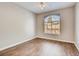 Bedroom with a ceiling fan, wood laminate flooring and a window overlooking the community at 1713 Sky Of Red Dr # 203, Las Vegas, NV 89128