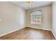 Bedroom with wood laminate flooring and a window providing natural light at 1713 Sky Of Red Dr # 203, Las Vegas, NV 89128