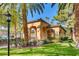 Inviting community clubhouse with lush landscaping, mature shade trees, and ample guest parking at 1713 Sky Of Red Dr # 203, Las Vegas, NV 89128