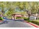 Gated Redhills community entrance with guard house, mature trees, and well-maintained landscaping at 1713 Sky Of Red Dr # 203, Las Vegas, NV 89128