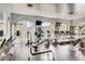 Spacious community gym with cardio machines, weightlifting equipment, mirrored walls, and natural light at 1713 Sky Of Red Dr # 203, Las Vegas, NV 89128