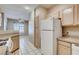Kitchen area featuring modern appliances and light wood cabinetry at 1713 Sky Of Red Dr # 203, Las Vegas, NV 89128