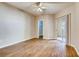 Spacious main bedroom with a ceiling fan, sliding glass door and wood laminate flooring at 1713 Sky Of Red Dr # 203, Las Vegas, NV 89128