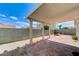 Backyard with covered patio and paved area at 1829 Fighting Falcon Ln, North Las Vegas, NV 89031