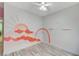 Bright bedroom featuring a unique mural, ceiling fan, and wood-look flooring at 1829 Fighting Falcon Ln, North Las Vegas, NV 89031