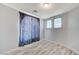 Cozy bedroom with wood-look flooring, neutral paint, and window coverings for natural light at 1829 Fighting Falcon Ln, North Las Vegas, NV 89031