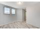 Neutral bedroom with two windows and light, wood-look flooring at 1829 Fighting Falcon Ln, North Las Vegas, NV 89031