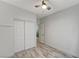 Bedroom with closet, ceiling fan, and wood-look flooring at 1829 Fighting Falcon Ln, North Las Vegas, NV 89031